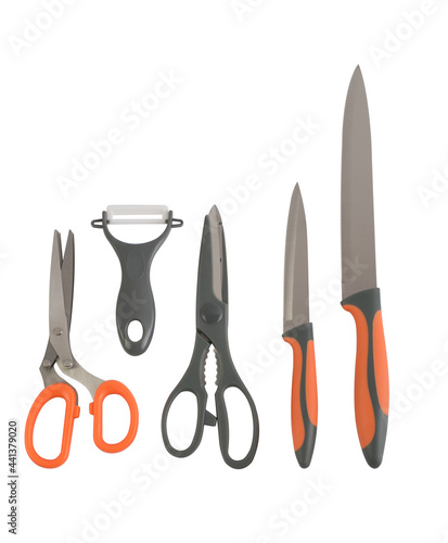 A group of knives, scissors and peeler isolated on white background