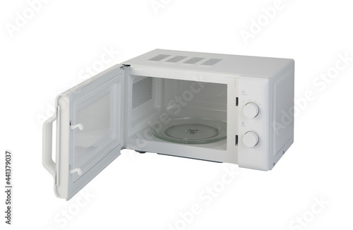 Opened white microwave oven with empty glass plate inside isolated on white background