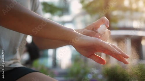 Wallpaper Mural Coronavirus concept. Person outdoor using sanitizer spray. Measures to prevent the spread of the covid-19 virus. Torontodigital.ca