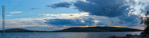 Evening on the White Sea. Panorama of the sea and sky with clouds in northern latitudes. Landscape at dusk, sunset and dramatic sky.