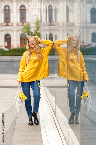Wallpaper Mural Girl in yellow raincoat with eco bag in the city in autumn Torontodigital.ca