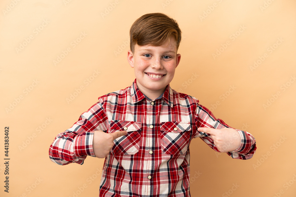 Little redhead boy isolated on beige background Little redhead boy isolated on beige background