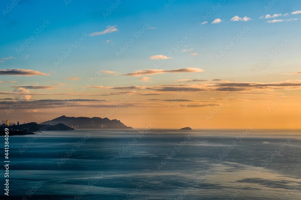 View of Benidorm on the Mediterranean Sea at sunrise from an old watchtower in El Campollo, Alicante Spain