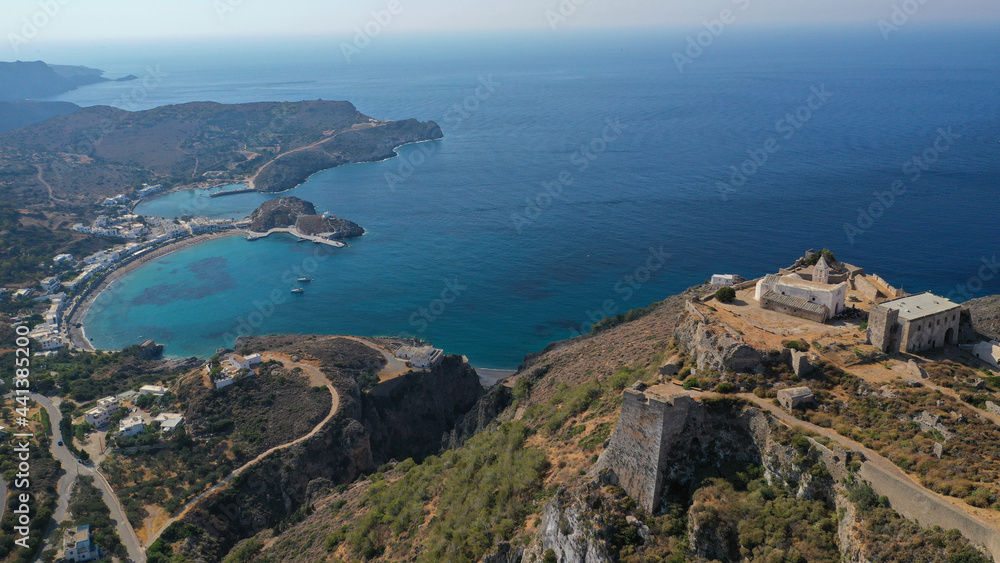Obraz premium Aerial drone photo above iconic medieval castle and main village of Kithira island overlooking beautiful double bay and beach of Kapsali, Kythira island, Ionian, Greece