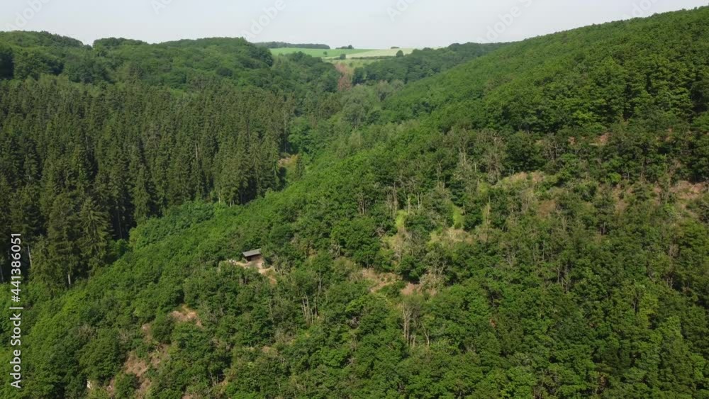 Drone shot of a single hut in the middle of nowhere in the German mountains. Zooming from the hut, revealing the nature. Drone shot of a single hut in the middle of nowhere in the German mountains. Zooming from the hut, revealing the nature.
