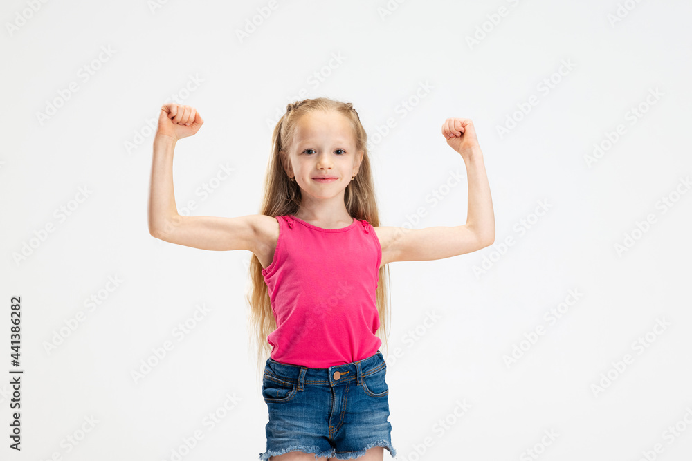 Half-length portrait of beautiful little girl in casual clothes posing isolated on white studio background. Happy childhood concept. Half-length portrait of beautiful little girl in casual clothes posing isolated on white studio background. Happy childhood concept.