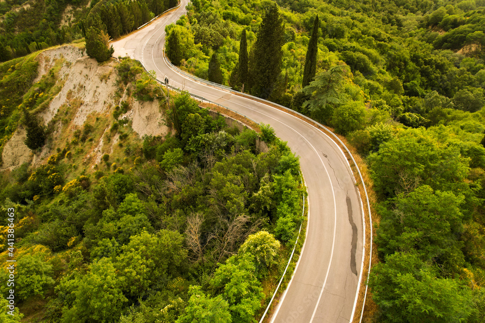 Beautiful idyllic summer landscape of Toscana with mediterranean plants, hills, trees, forests and fields. Sunny evening or morning in Italy. Vacation, recreation mood. Road in hills of Tuscany Beautiful idyllic summer landscape of Toscana with mediterranean plants, hills, trees, forests and fields. Sunny evening or morning in Italy. Vacation, recreation mood. Road in hills of Tuscany