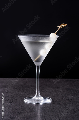 Gibson martini cocktail with onions on black background photo