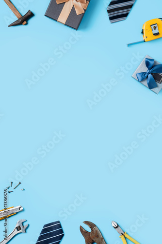 Top view design concept of Father's day with working tools on blue background.