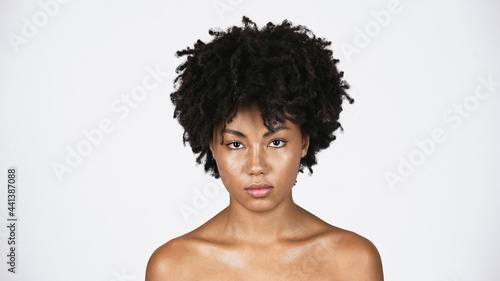 African american woman with perfect skin looking at camera isolated on grey