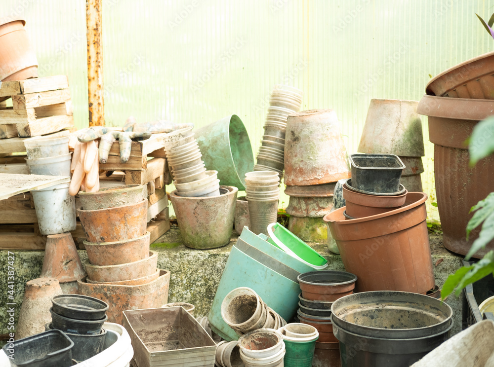 various used plastic and clay pots for plant covered with dirt various used plastic and clay pots for plant covered with dirt