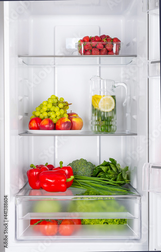 Open fridge full of fresh fruits and vegetables