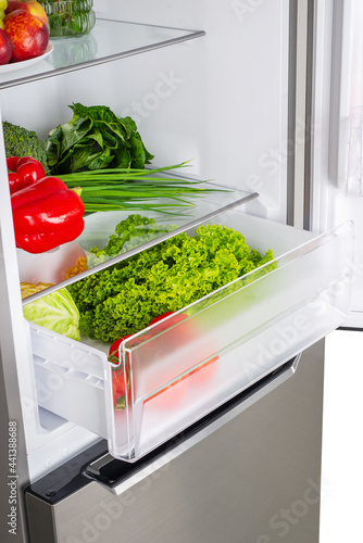 Open fridge full of fresh fruits and vegetables