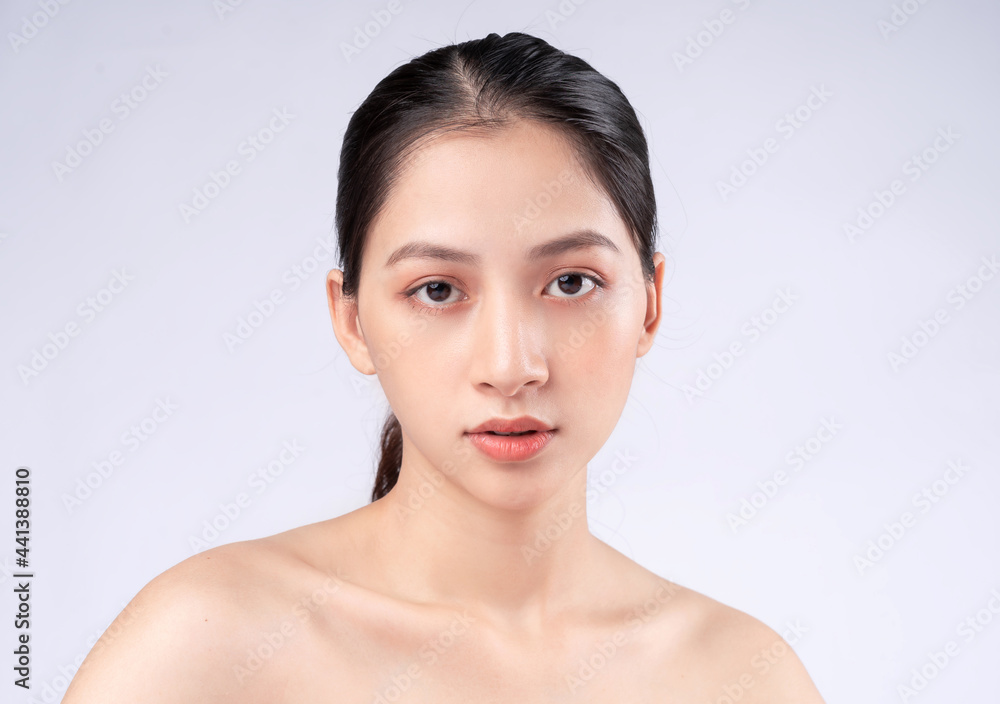 Attractive young Asian woman with youthful skin. Facial care, facial treatment, woman beauty skin isolated on white background. cosmetology, skin beauty and cosmetic concept Attractive young Asian woman with youthful skin. Facial care, facial treatment, woman beauty skin isolated on white background. cosmetology, skin beauty and cosmetic concept