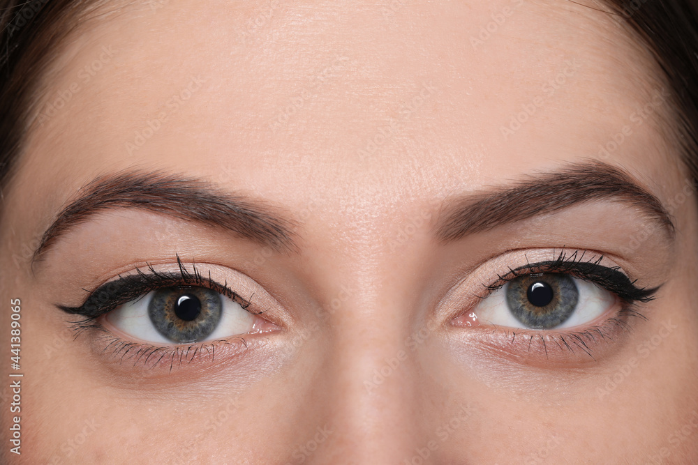 Naklejka premium Beautiful woman with black eyeliner, closeup view