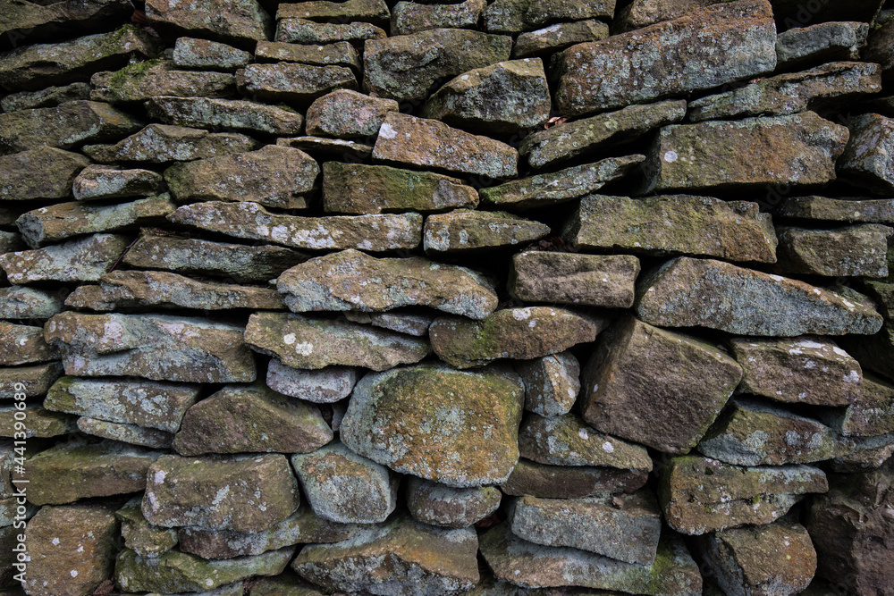 Dry stone wall background with textured rocks and stones. Dry stone wall background with textured rocks and stones.
