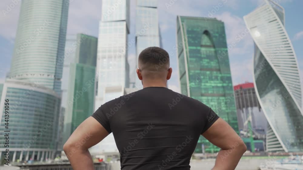 A tourist admires the Moscow City complex. A man looks at skyscrapers in the center of Moscow. Travel through the cities of Russia. A tourist looks at the building Moscow City in the city of Moscow. A A tourist admires the Moscow City complex. A man looks at skyscrapers in the center of Moscow. Travel through the cities of Russia. A tourist looks at the building Moscow City in the city of Moscow. A