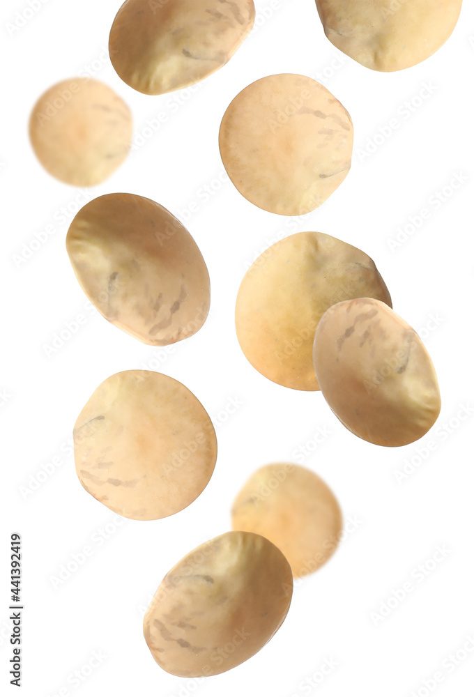 Fototapeta premium Many lentils falling on white background. Vegan diet