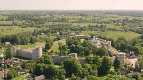 Aerial view of Izborsk fortress in Russia. Semi-ruined walls, towers and courtyards around a 14th-century fortress photo