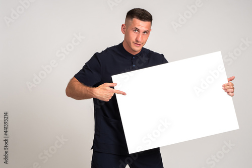 Man points to blank banner....