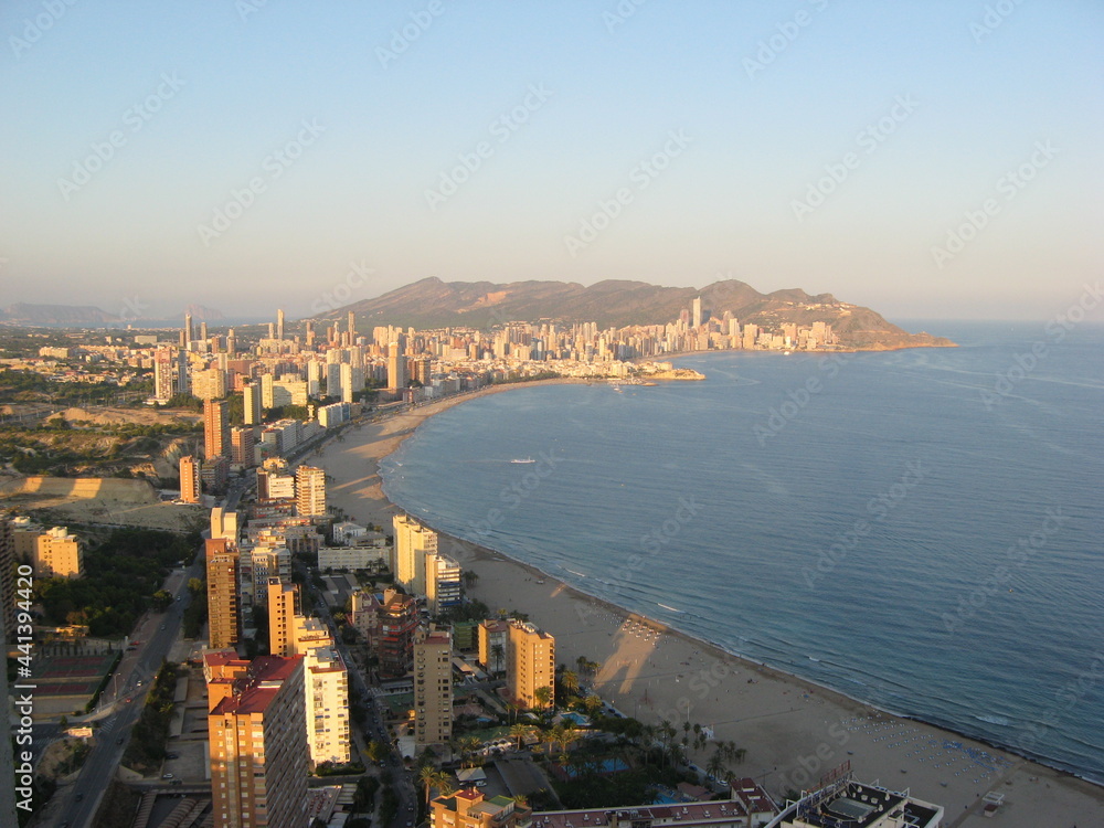 view from the window of high-rise buildings, blue sea and hotels. sunny day on the Costa Blanca. Benidorm, Spain