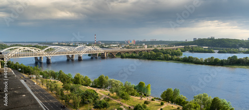 Panoramic view of the right bank of Kyiv. Dnieper river, evening and sunset. Metro bridge. Sight. Nice view from the balcony. © Real_life