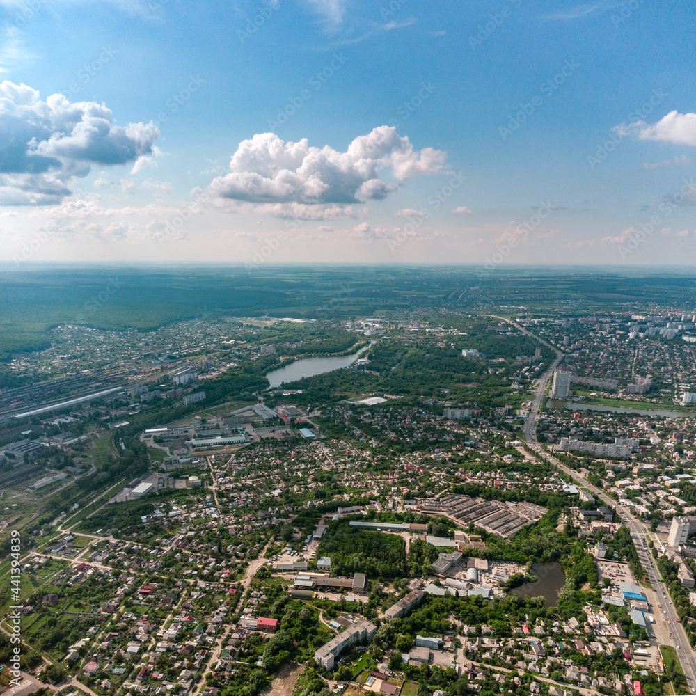 Aerial high view Kharkiv city Shevchenkivskyi district with Udy river, urban and residential multistory buildings with scenic colorful cloudy sky in summer