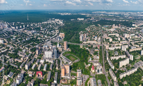 Aerial view on green summer Kharkiv city center, Pavlovo pole and park. Botanical garden Sarzhyn Yar, stadium and multistory modern high residential buildings on bright sunny day