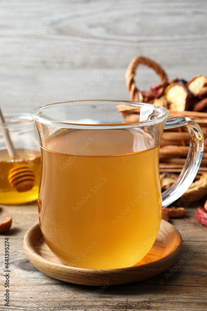 Delicious compote in glass cup on wooden table, closeup Delicious compote in glass cup on wooden table, closeup