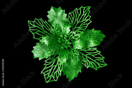 Green flower dark black background isolated close up  beautiful green metal flower  shiny metallic leaves  floral pattern  Christmas tree decoration  New Year decor  vintage decorative design element