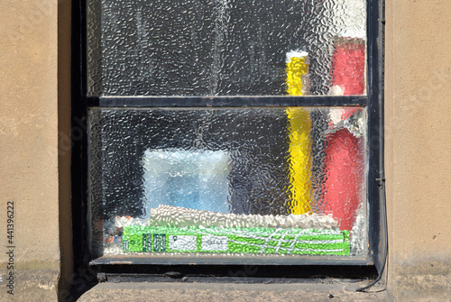 Εκτύπωση καμβά Window with Colourful Items Seen through  Textured Clear Glass