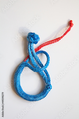 brilliant knot soft shackle woven of blue nylon or polyester rope isolated on white background. lighter than a carabiner. Tourist equipment