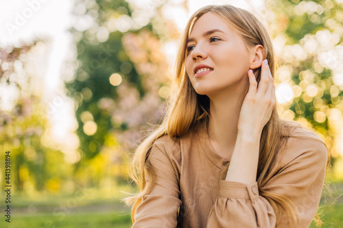 young woman smiling in the park at sunset time, street portrait of a smiling woman, Happy cheerful woman laughing in the park