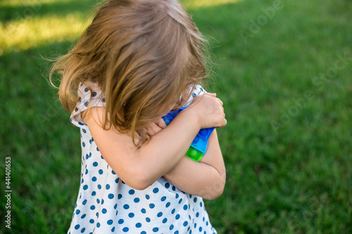 little girl playing in nature Push pop Bubble Pop it