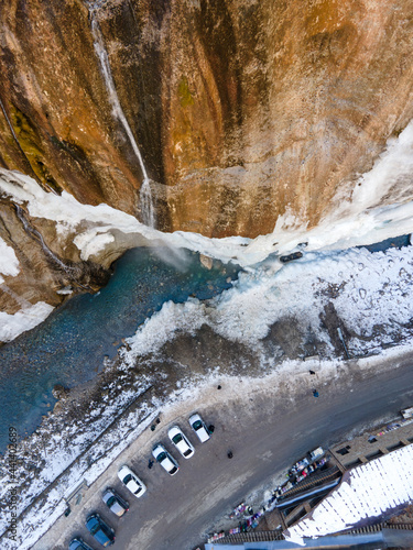 A waterfall in the snow. High quality photo. Shooting with a drone. Vertical view. Chegem waterfalls in winter photo