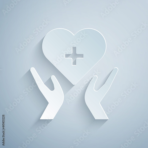 Paper cut Heart with a cross icon isolated on grey background. First aid. Healthcare, medical and pharmacy sign. Paper art style. Vector