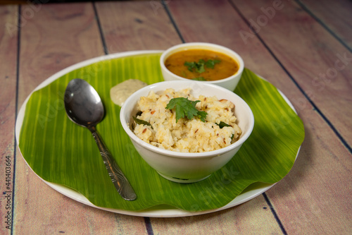 ven pongal traditional indian food served on a white bowl photo