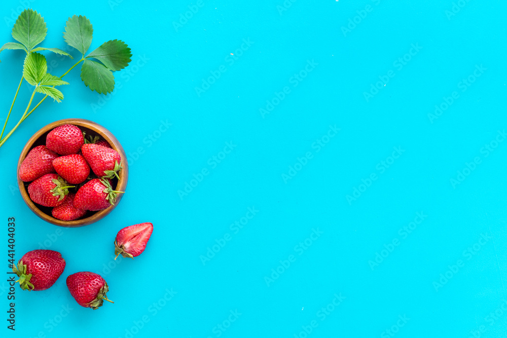 Fresh strawberry with leaf in bowl. Berry background. Top view Fresh strawberry with leaf in bowl. Berry background. Top view