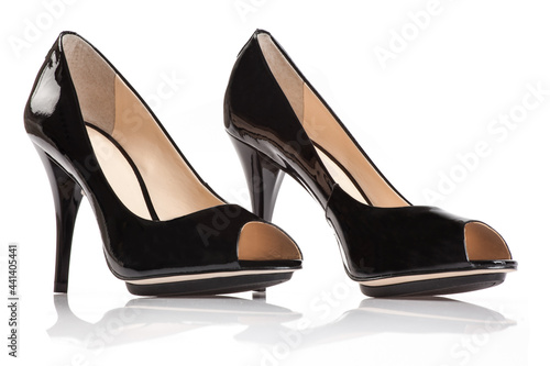 Black patent female shoe on white background.