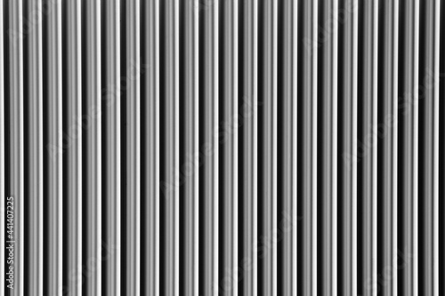 Abstract silver background with vertical lines, lit with a soft light.