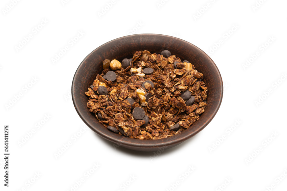 Chocolate granola cereal with nuts in a bowl background. Chocolate granola cereal with nuts in a bowl background.