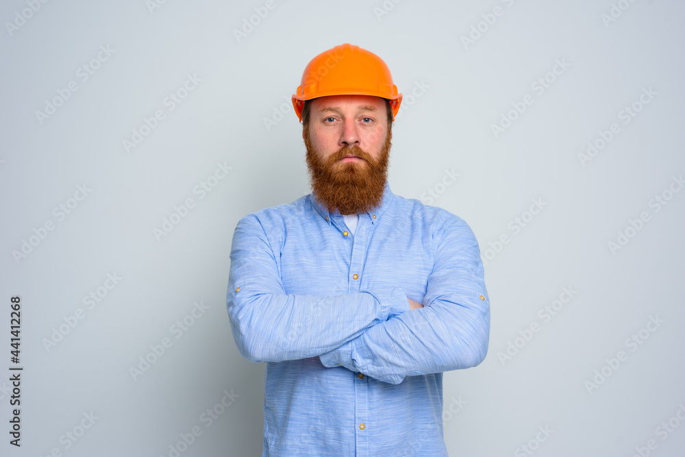 Isolated confidant architect with beard and orange helmet