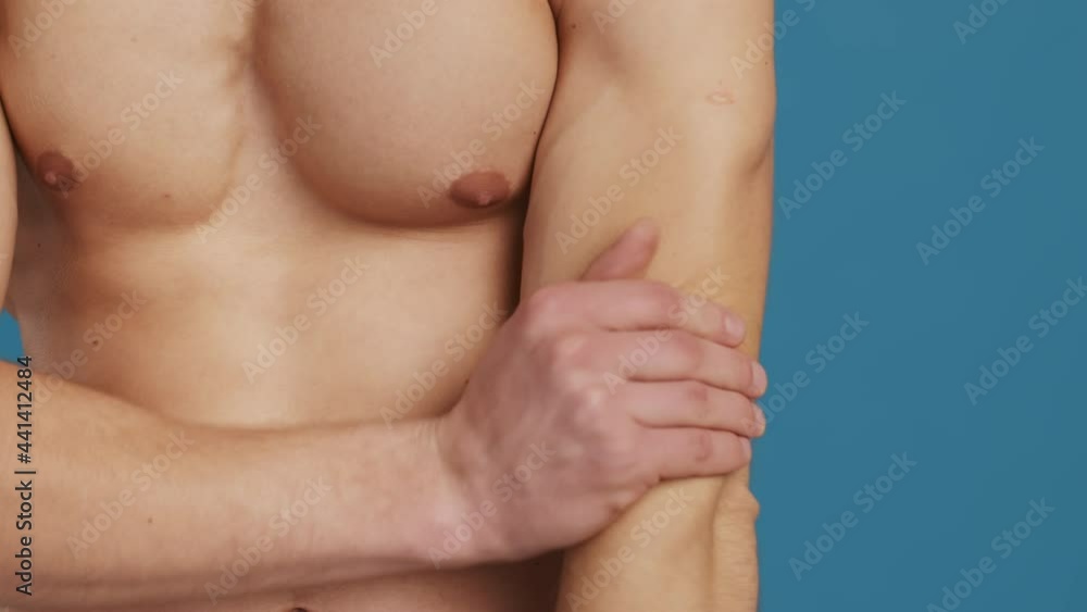 Psoriasis prevention. Close up shot of young man with skin problems applying treatment cream on his dry elbows Psoriasis prevention. Close up shot of young man with skin problems applying treatment cream on his dry elbows