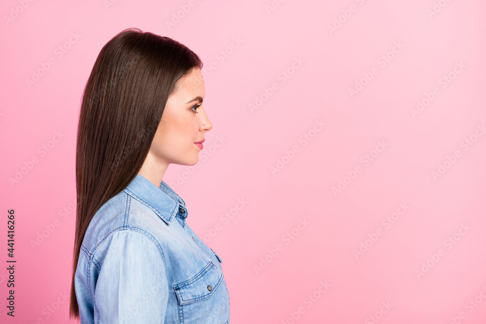 Profile side view portrait of winsome content brown-haired girl copy space ad isolated over pink pastel color background Profile side view portrait of winsome content brown-haired girl copy space ad isolated over pink pastel color background