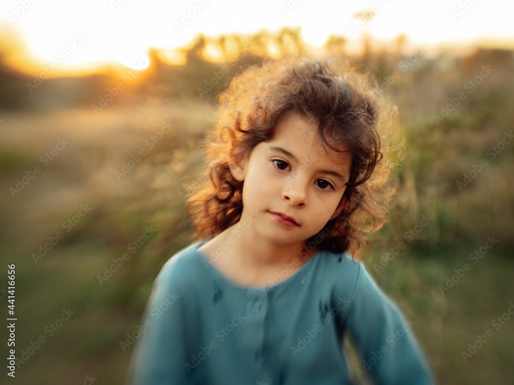 Little girl with curly hair in nature Little girl with curly hair in nature