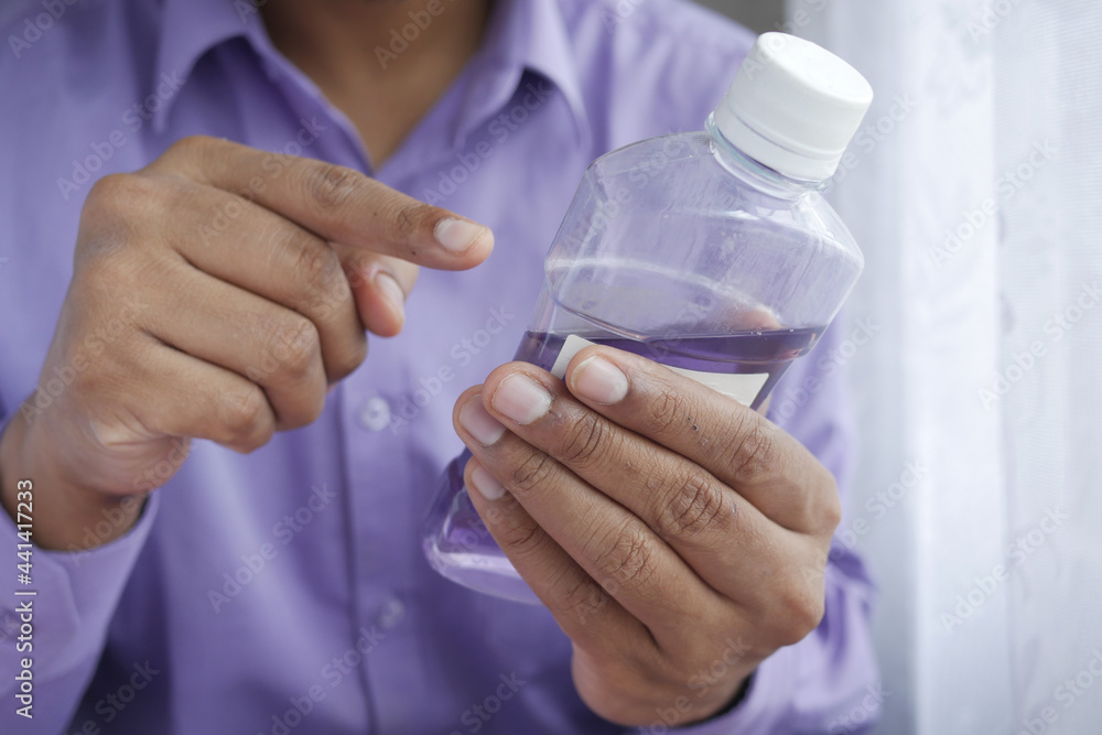 mouthwash liquid flowing into a cap mouthwash liquid flowing into a cap