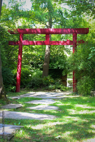 Red Torii gates and lacquered arched bridge in a Japanese zen  gardens. This park is the Friendship Park  a public garden located in Rueil-Malmaison in the Hauts-de-Seine in France.  