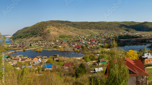 Small town on the background of the river and mountains.
