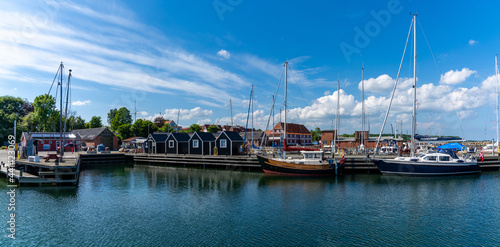 picturesque harbor and marina of Lundeborg on Funen island in Denmark with sailboats moored at the docks photo