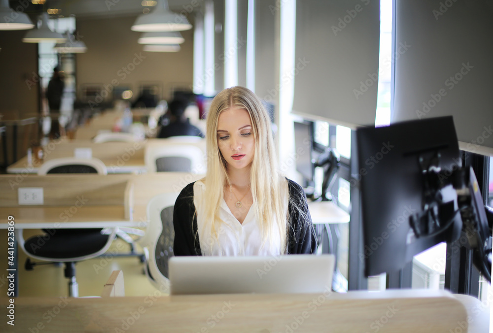 Smiling woman using laptop in work place for small businesses looking to engage audiences and scale content creation can adopt new marketing technology in workspace. Freelancer concept. Smiling woman using laptop in work place for small businesses looking to engage audiences and scale content creation can adopt new marketing technology in workspace. Freelancer concept.